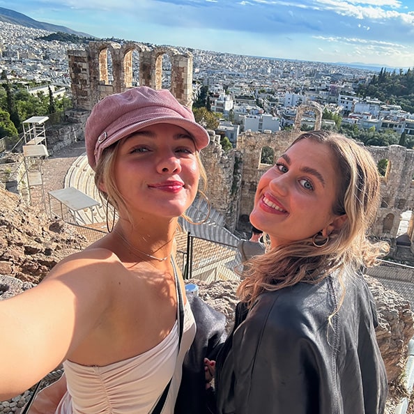 Fairfield students taking a smiling selfie from one of the upper viewing areas of the Roman Colosseum.